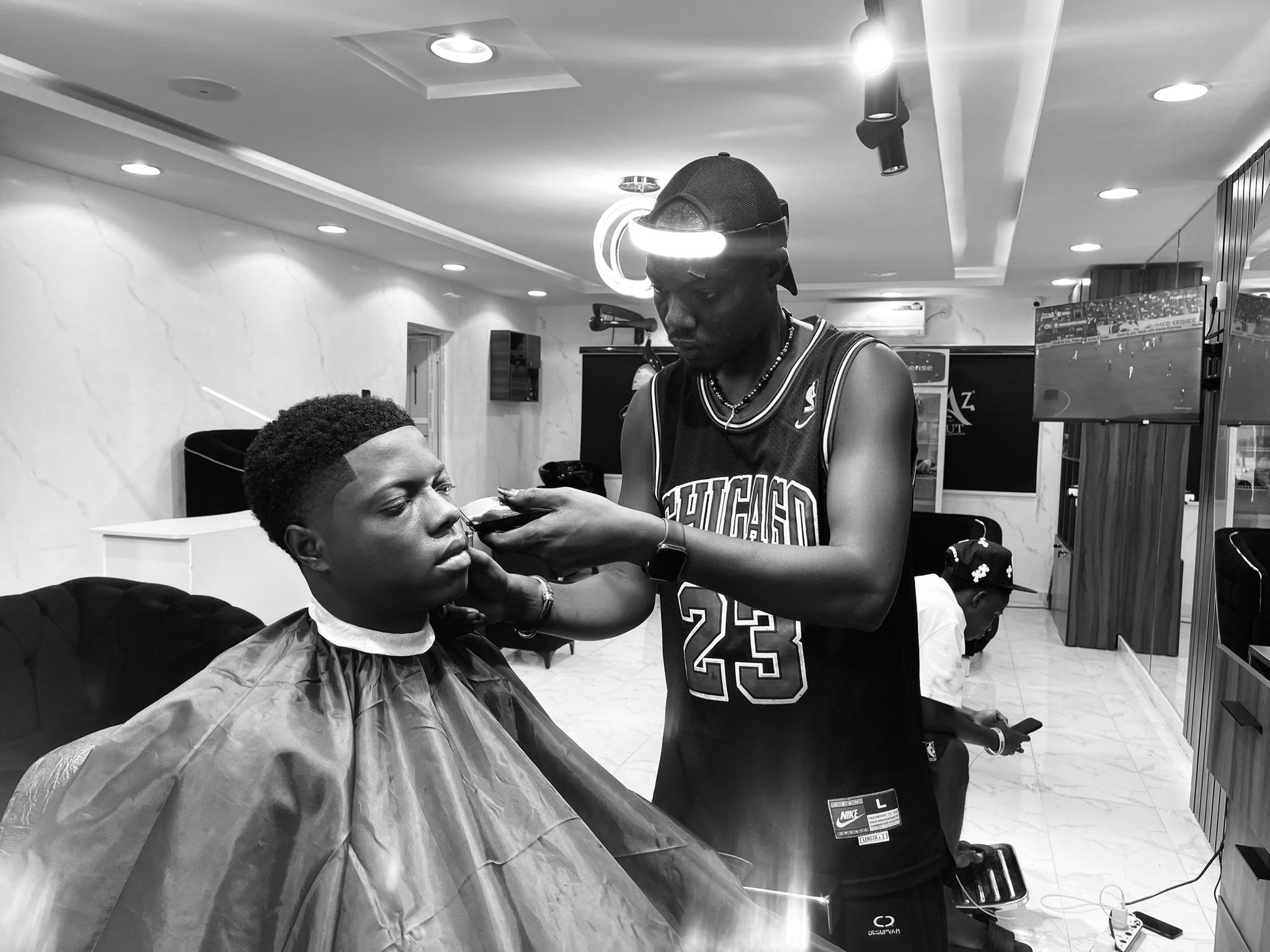 AZ Studio master barber giving a custom fade in Lagos